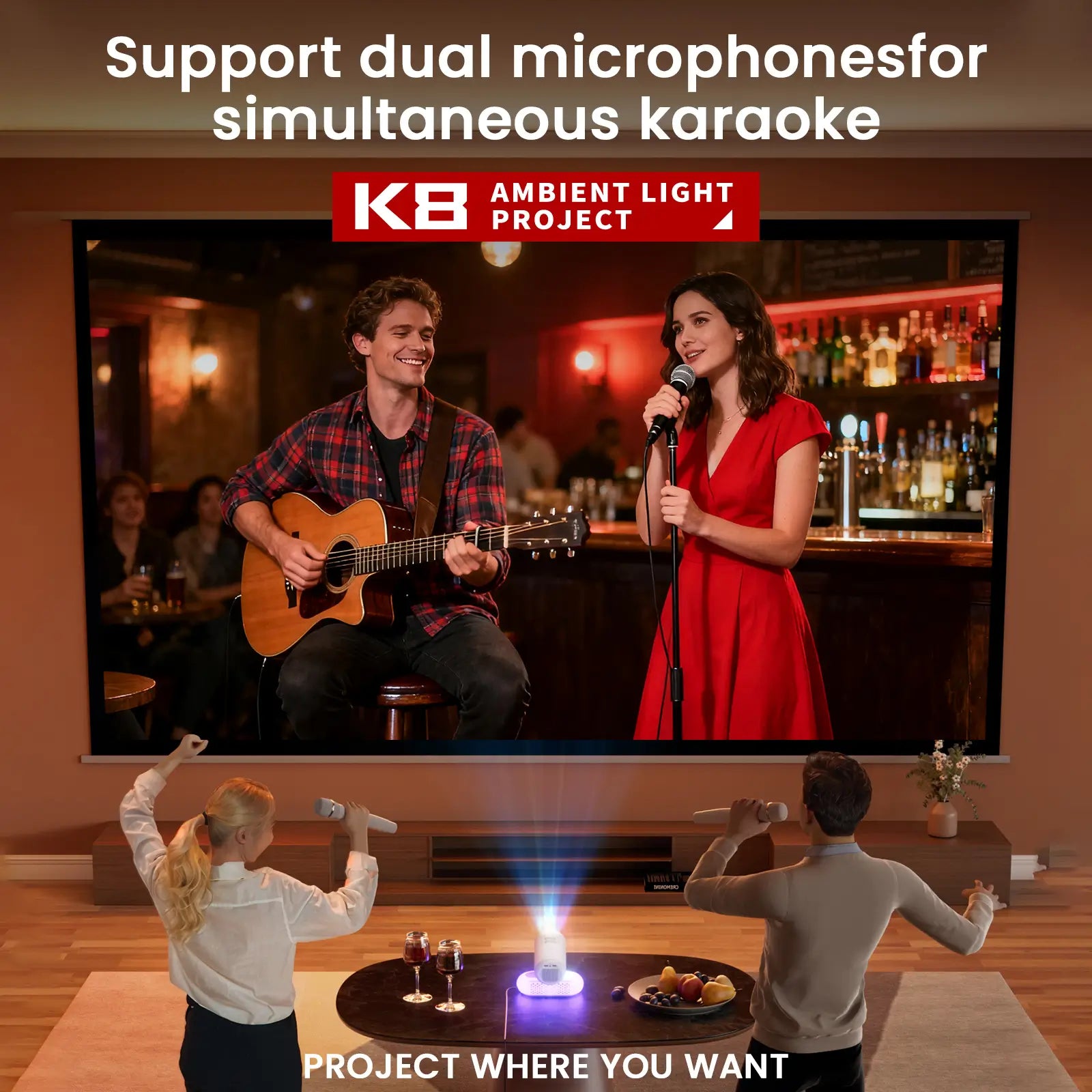 A couple enjoying a karaoke party at home with the Geitepor K8 projector, using two wireless microphones to sing along to a duet on the large screen.