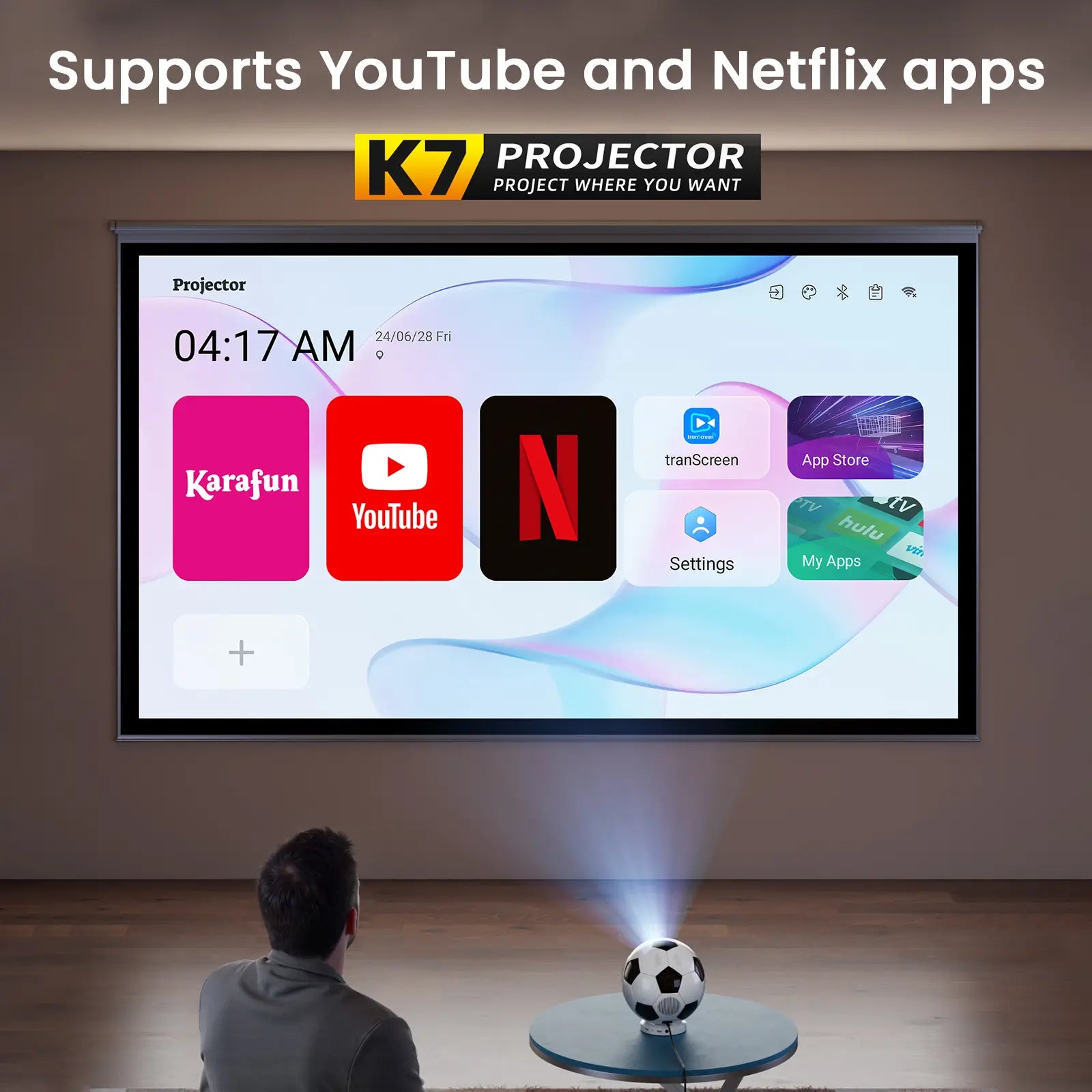 A man looking at the K7 projector's smart TV interface, which features built-in apps like YouTube and Netflix for easy streaming.