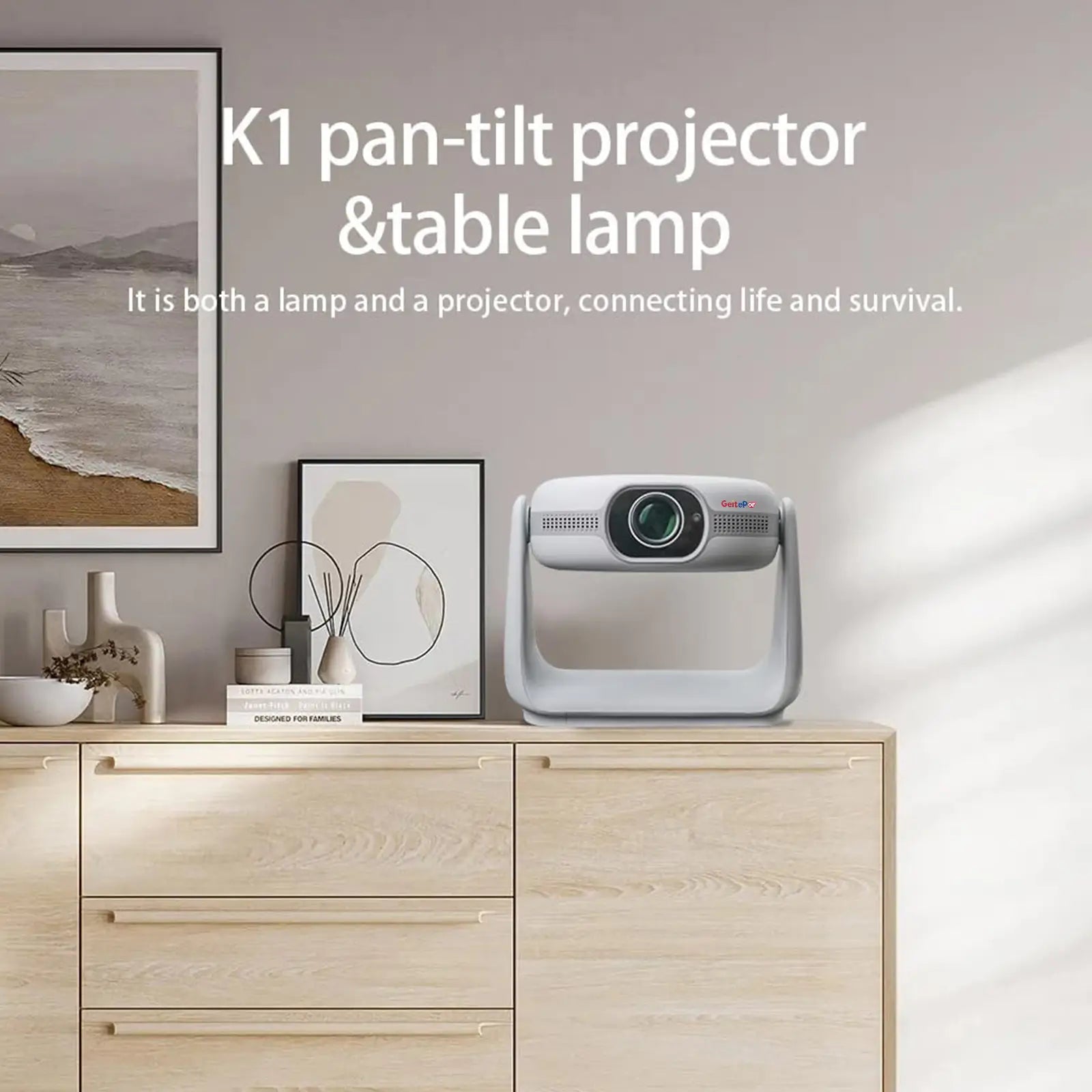 The stylish K1 projector displayed on a cabinet in a modern home, showcasing its dual function as both a pan-tilt projector and a table lamp.