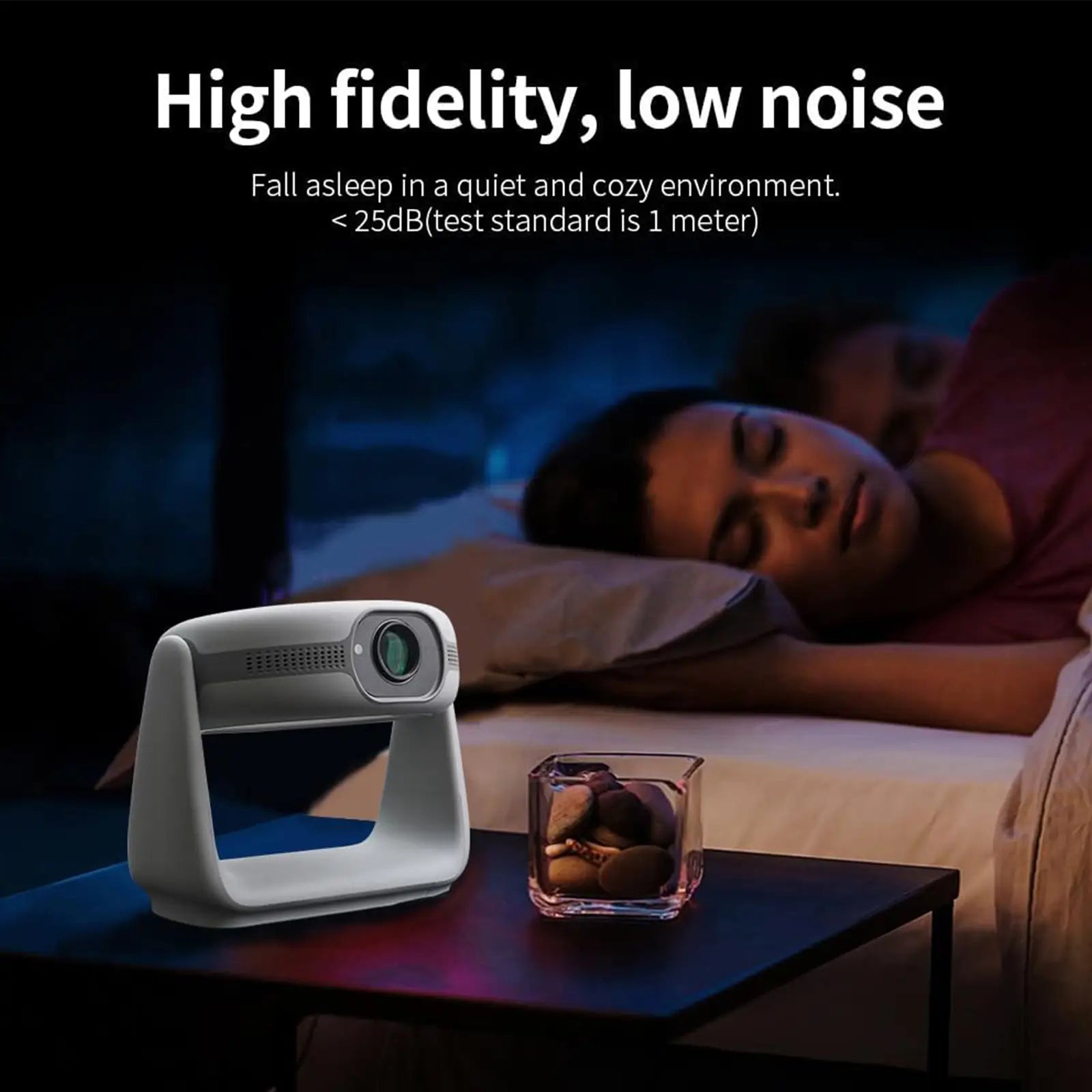 The K1 projector sitting on a bedside table, highlighting its ultra-quiet, low-noise operation (under 25dB) for a peaceful environment.